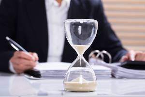 hourglass on table with documents