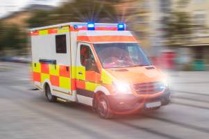 ambulance on road with flashing lights