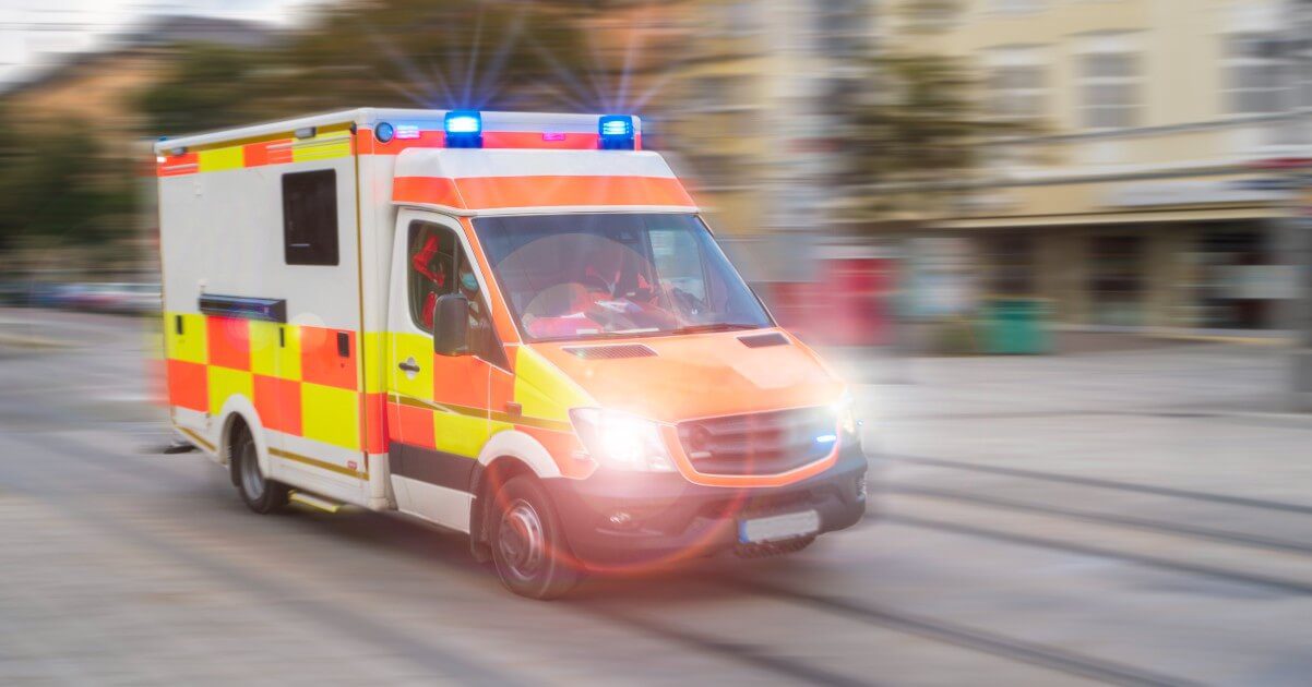 ambulance on road with flashing lights