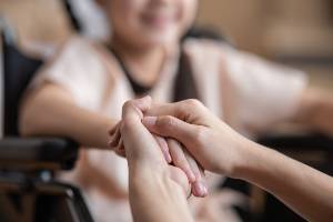 child smiling in wheelchair