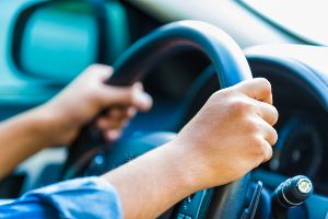 woman's hands on steering wheel