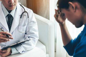 patient with migraine in doctor's office