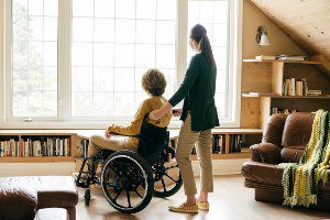 caregiver with patient in wheelchair