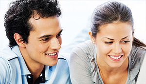 Young Canadian couple looking at a laptop.