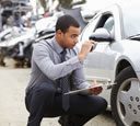 man inspecting his vehicle after an accident