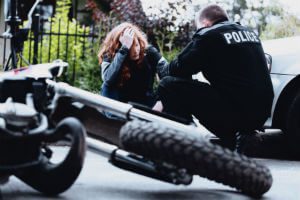 police talking to motorcycle crash victim