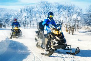 riding snowmobiles