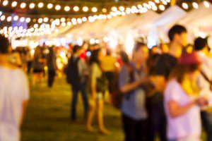outdoor festival with lights hanging up