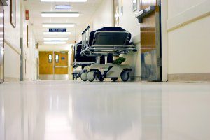empty hallway in hospital with empty bed