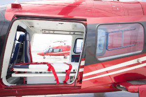 red helicopter with stretcher inside