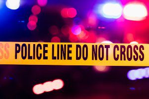yellow police line with lights behind