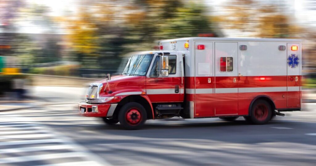 ambulance on road during sunny day