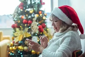 woman in santa hat about to make phone call
