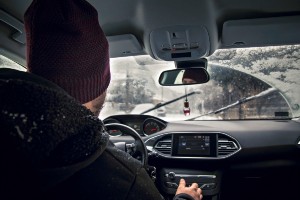man driving on snow or black ice roadway