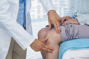 doctor examining painful injury